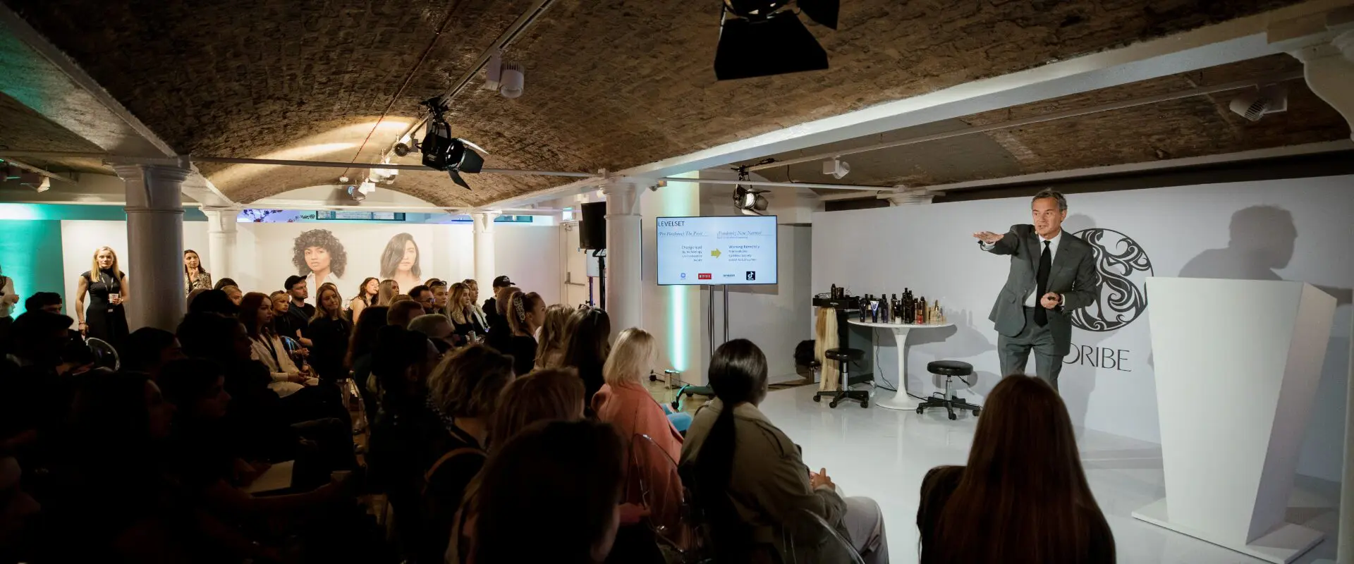 Speaker presenting to a seated audience at a brand launch event