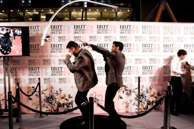 Guests photographed against a branded press wall at an awards event