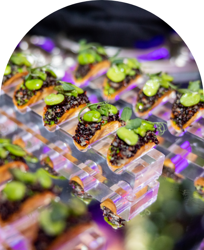 Canapés served on clear acrylic risers at a drinks reception
