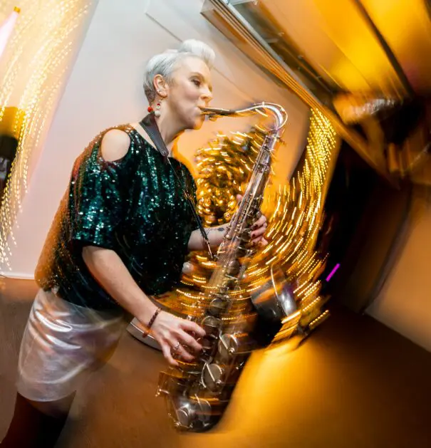 Saxophonist performing in sequins at an event