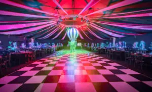 Circus themed party with a chequerboard dancefloor and hot air balloon