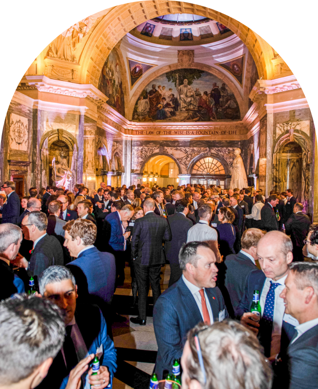 Guests at a reception in an ornate domed hall