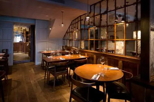 Restaurant dining room with wooden interior and banquette seating