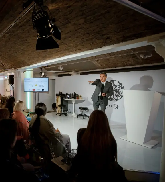Speaker presenting to a seated audience at a brand launch event