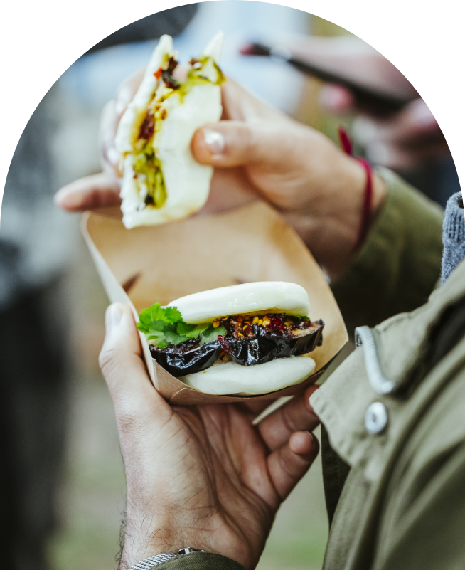 Filled bao bun served from a street food stall at an event