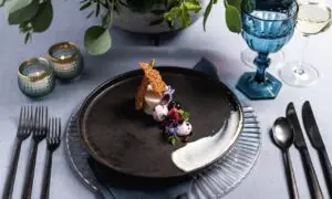 Plated fine dining course with glassware