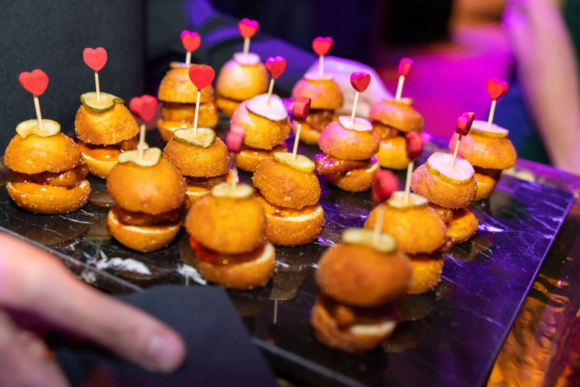 Mini burgers served on a canapé tray