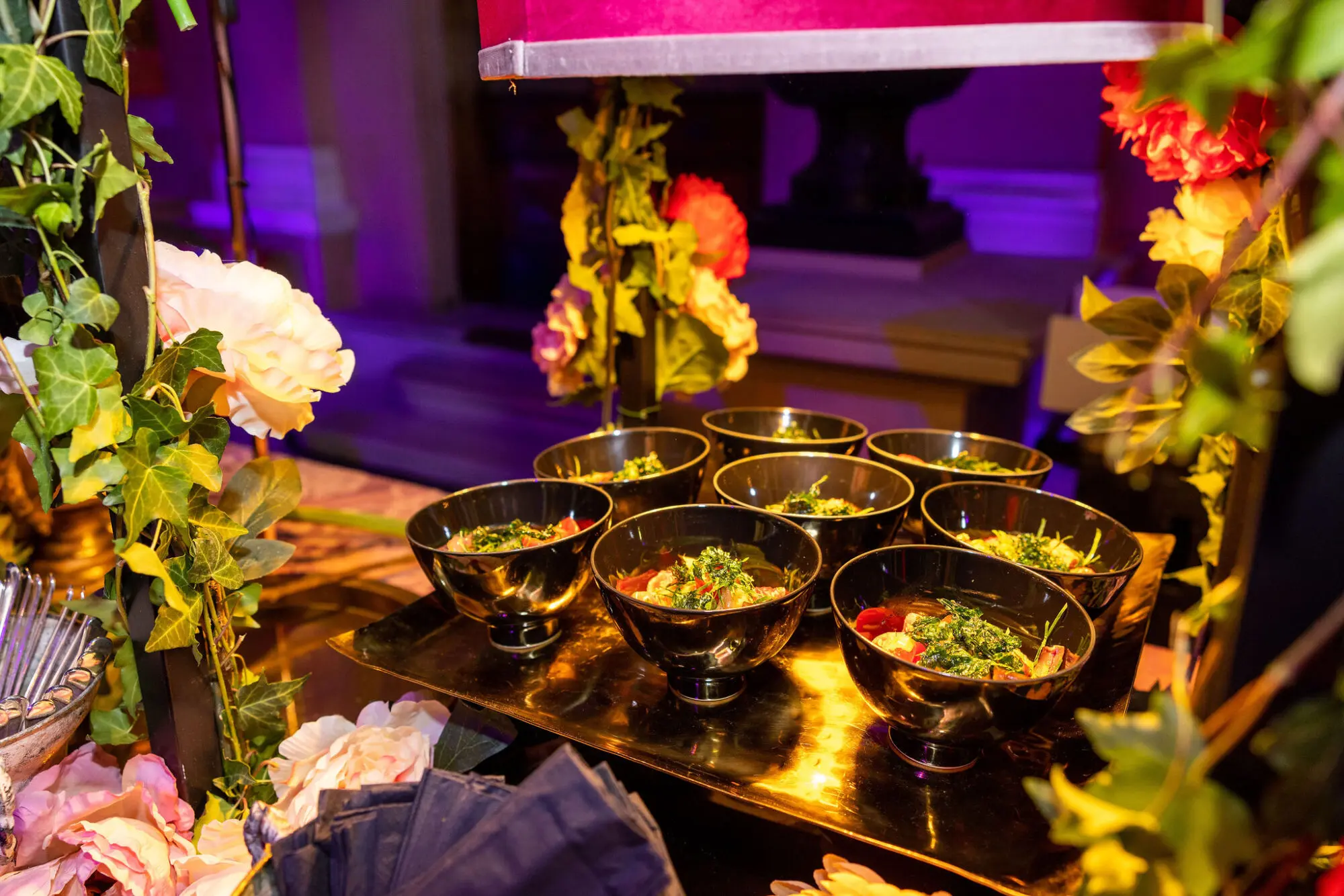 Canapés displayed among flowers and foliage