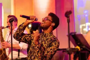 Singer performing with a live band at a corporate party