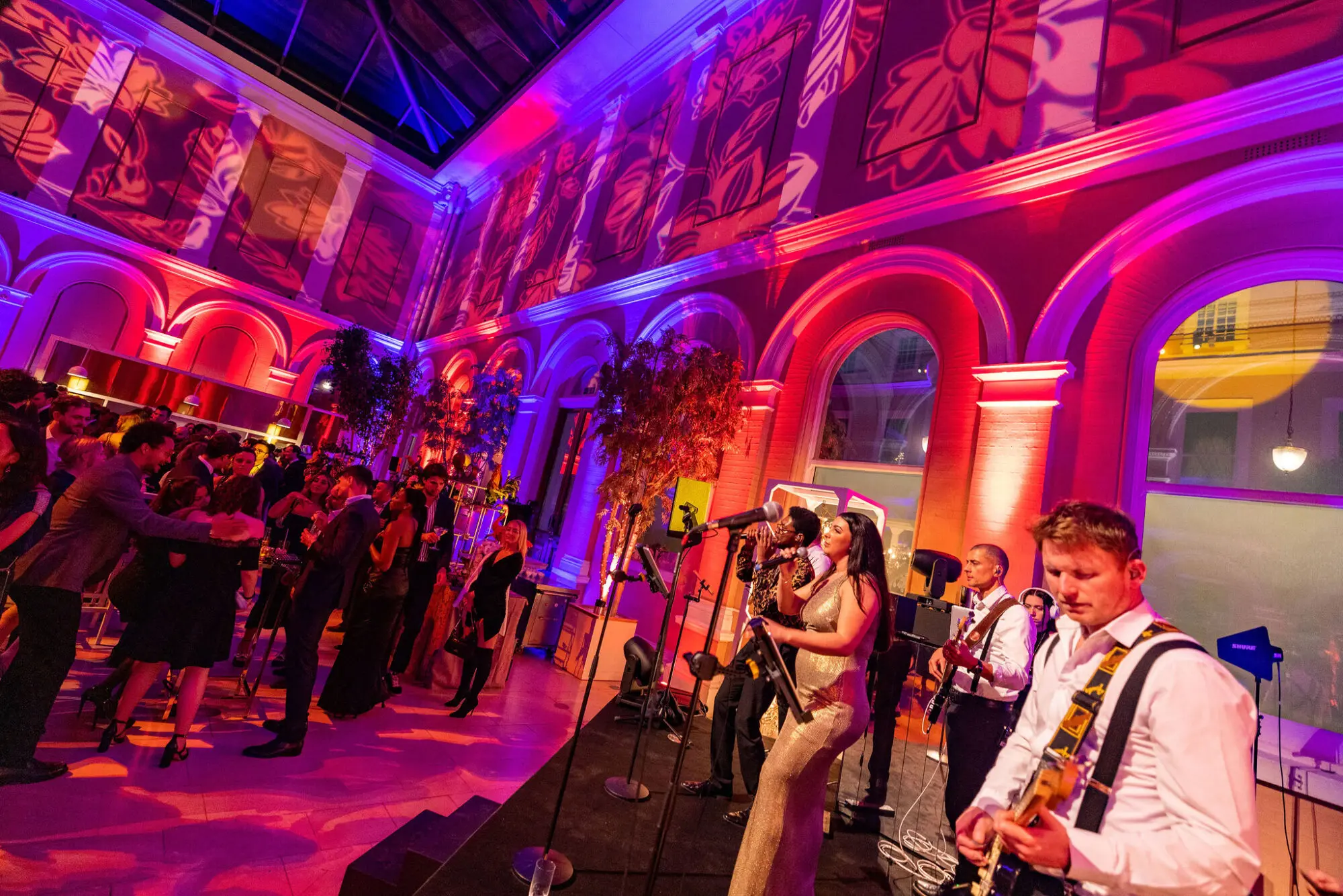 Saxophonist performing among guests on the dancefloor