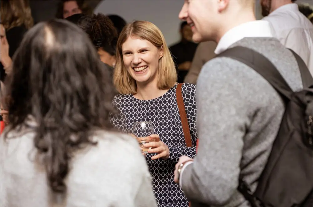 Guests networking with drinks at a conference