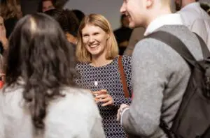 Guests networking with drinks at a conference