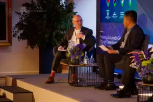 Fireside chat between two speakers on stage at a conference