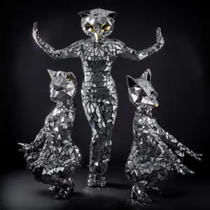 Mirrored animal-head performers posed against a black backdrop