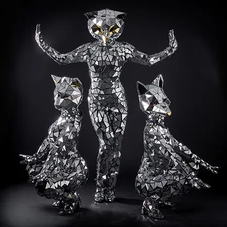 Mirrored animal-head performers posed against a black backdrop