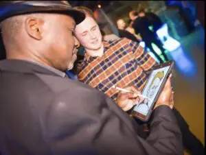 Caricaturist sketching guests at an event