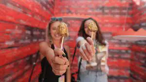 Guests posing at a red photo wall