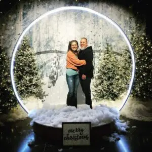 Guests posing inside a giant snow globe photo opportunity