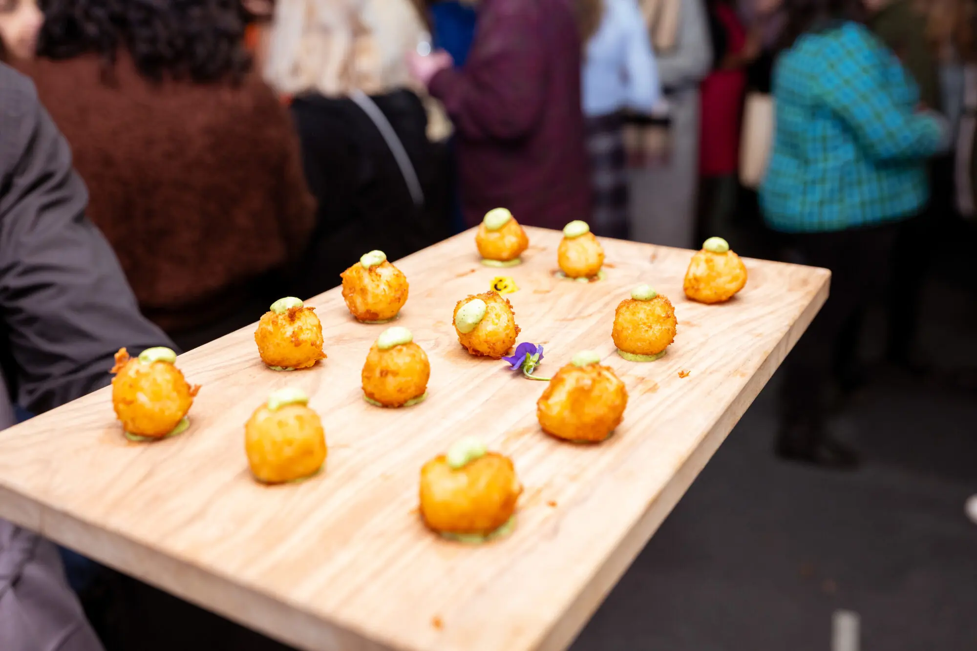 Canapés laid out on a wooden serving table