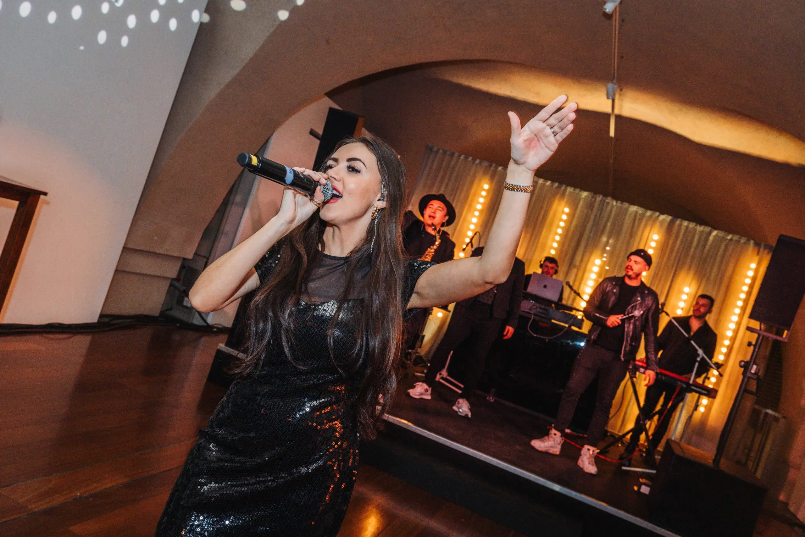 Singer performing with a live band at a corporate event