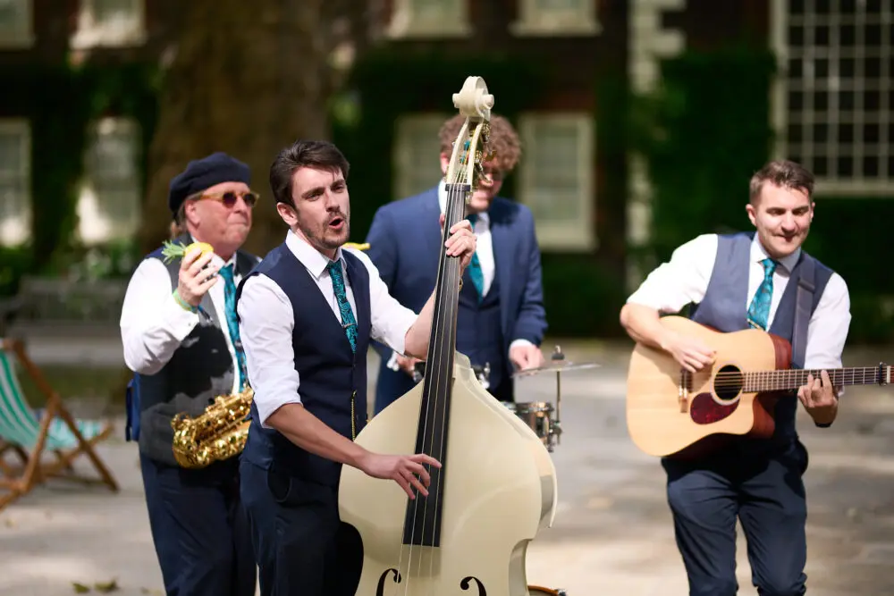 Four-piece live band performing outdoors at a summer party
